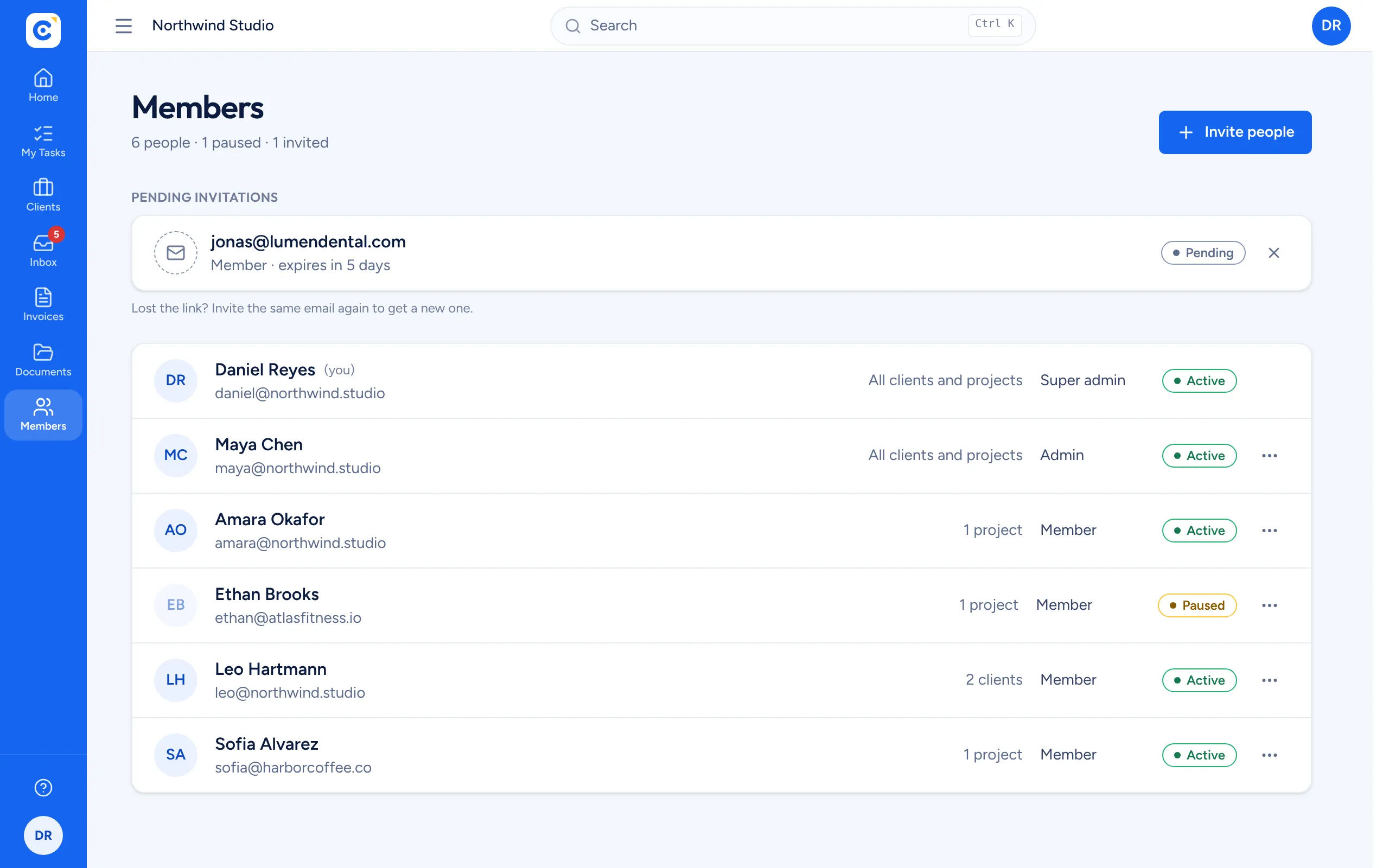 The members list with roles, client and project access, and active or paused status